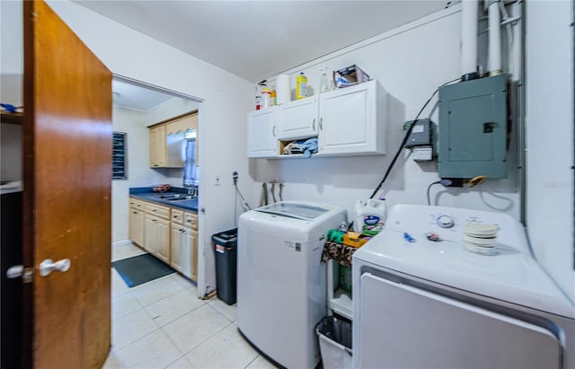 laundry room featuring washer and clothes dryer, cabinets, electric panel, sink, and light tile patterned floors