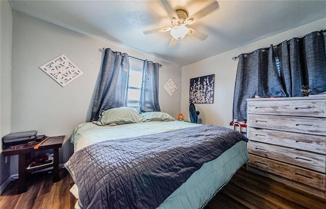 bedroom with ceiling fan and dark hardwood / wood-style floors