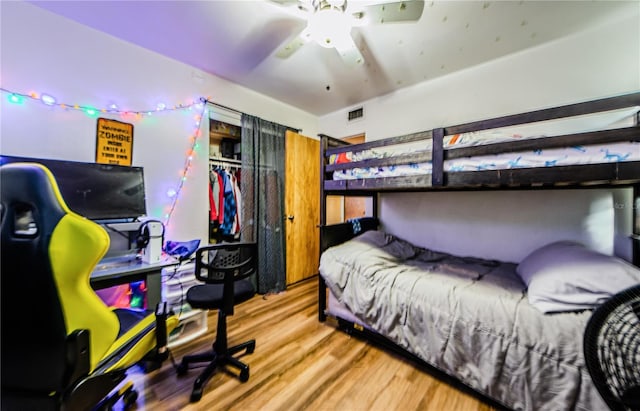 bedroom featuring a closet, hardwood / wood-style flooring, and ceiling fan