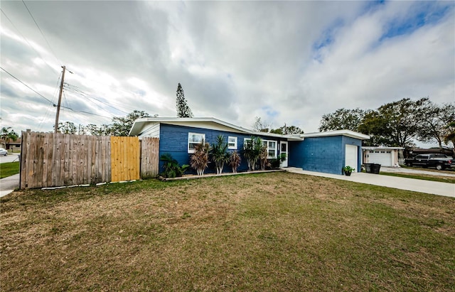 single story home featuring a garage and a front yard