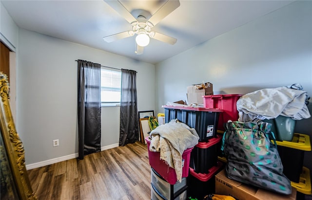 interior space with wood-type flooring and ceiling fan