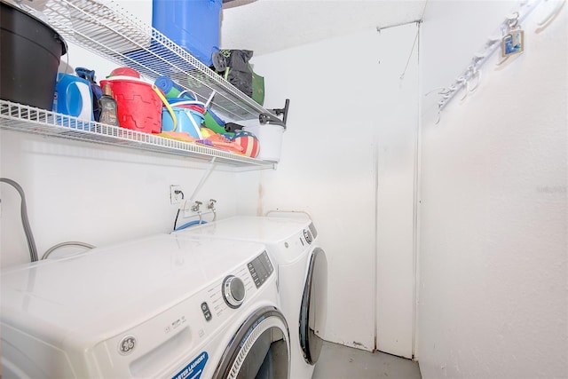 laundry area with washing machine and clothes dryer