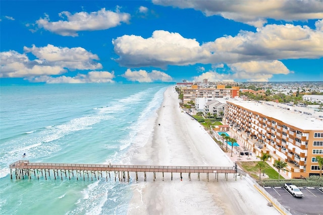 drone / aerial view with a water view and a beach view