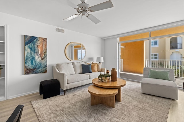 living room featuring ceiling fan and light wood-type flooring