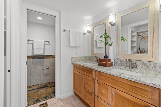 bathroom featuring vanity, tile walls, and a shower