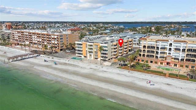 birds eye view of property featuring a water view and a beach view