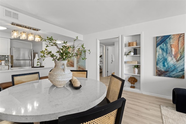 dining space featuring light hardwood / wood-style flooring