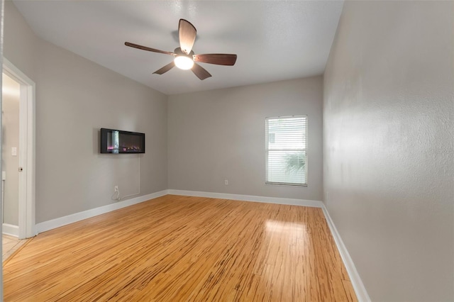 empty room featuring ceiling fan and light hardwood / wood-style flooring