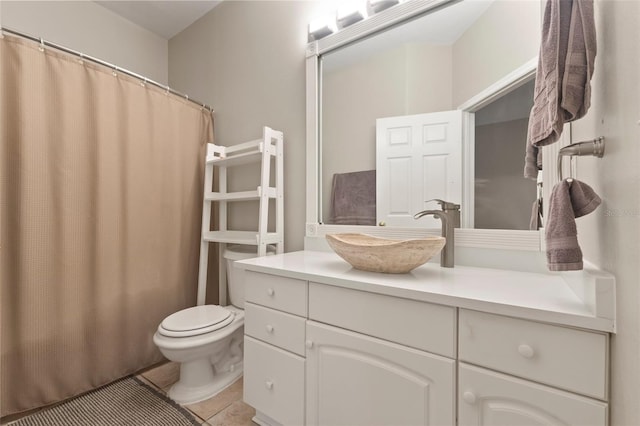 bathroom featuring tile patterned flooring, vanity, and toilet