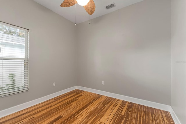 empty room featuring hardwood / wood-style flooring and ceiling fan