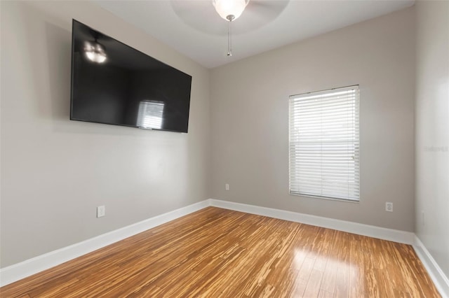 unfurnished room with hardwood / wood-style flooring and ceiling fan