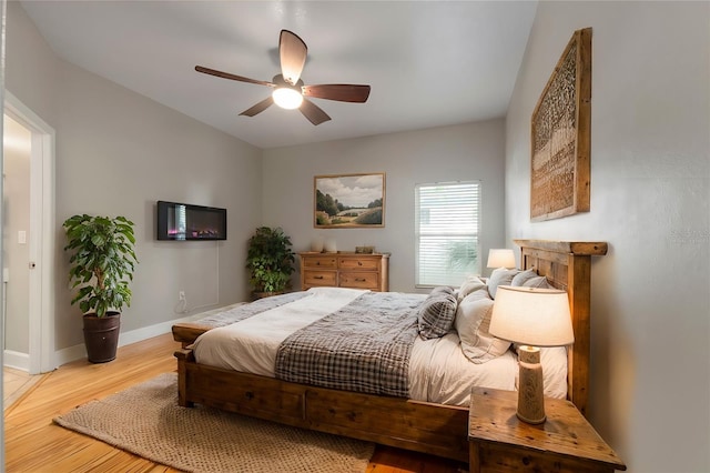 bedroom with ceiling fan and wood-type flooring