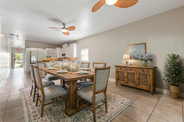 tiled dining area featuring ceiling fan and plenty of natural light