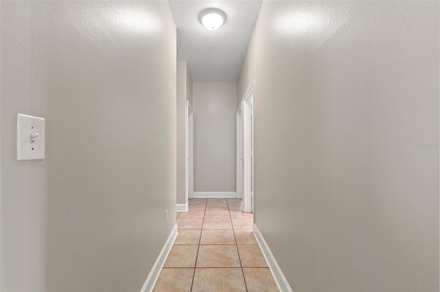 hall with light tile patterned floors