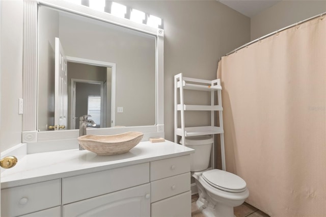 bathroom featuring tile patterned floors, vanity, and toilet