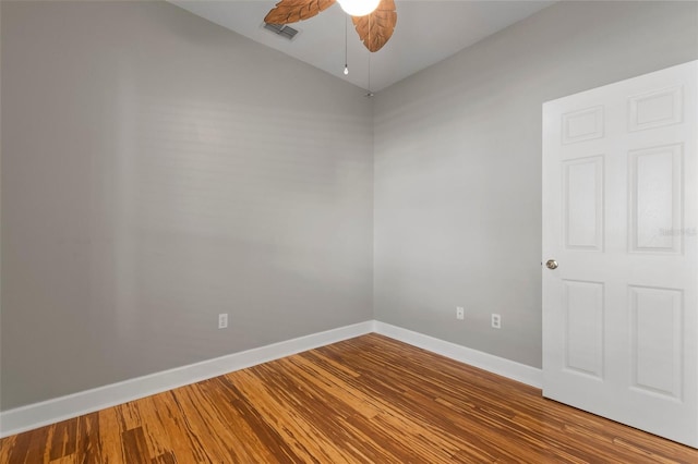 empty room with hardwood / wood-style flooring and ceiling fan