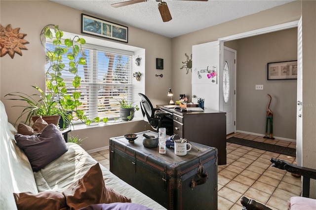 office featuring ceiling fan, light tile patterned floors, and a textured ceiling