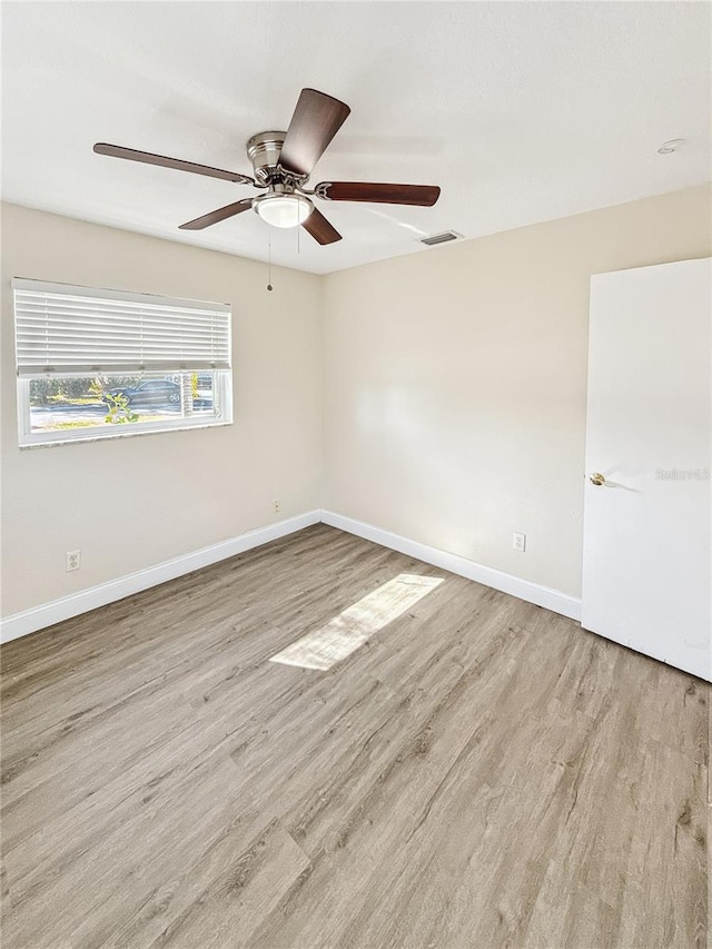 unfurnished room with light hardwood / wood-style flooring and ceiling fan