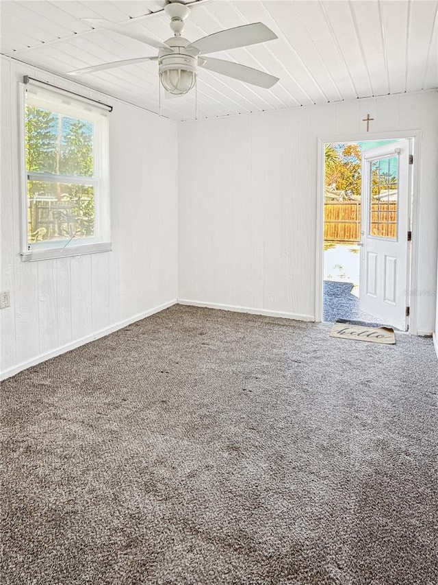 unfurnished room with ceiling fan and carpet