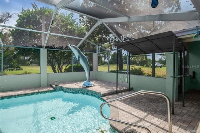 view of swimming pool featuring a lanai and a patio