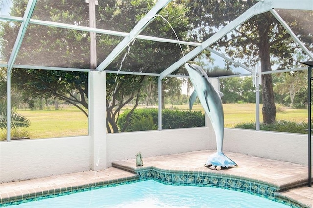 view of pool featuring glass enclosure and a patio