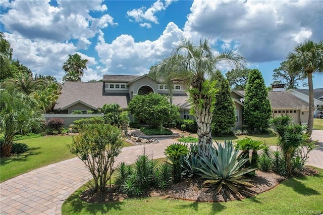 mediterranean / spanish-style house featuring a front lawn