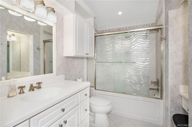 full bathroom featuring combined bath / shower with glass door, vanity, toilet, and tile patterned flooring