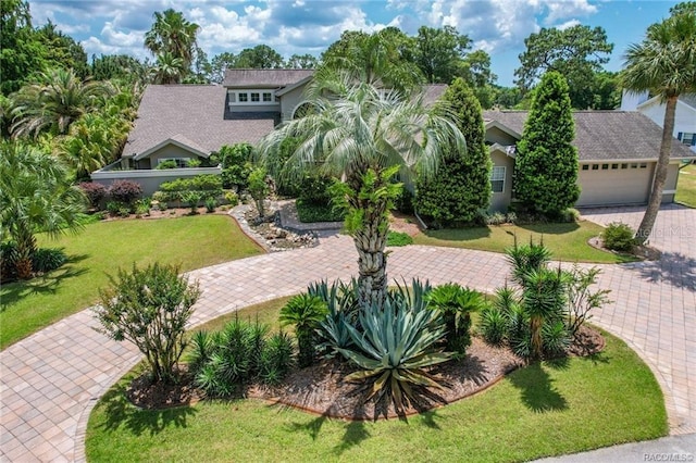 view of front of home with a front lawn and a garage