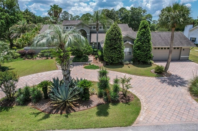 view of front of home with a front yard and a garage