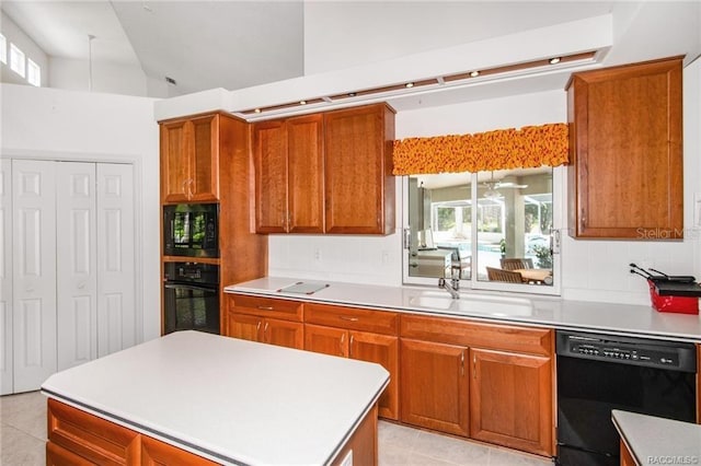 kitchen featuring high vaulted ceiling, black appliances, sink, tasteful backsplash, and a kitchen island