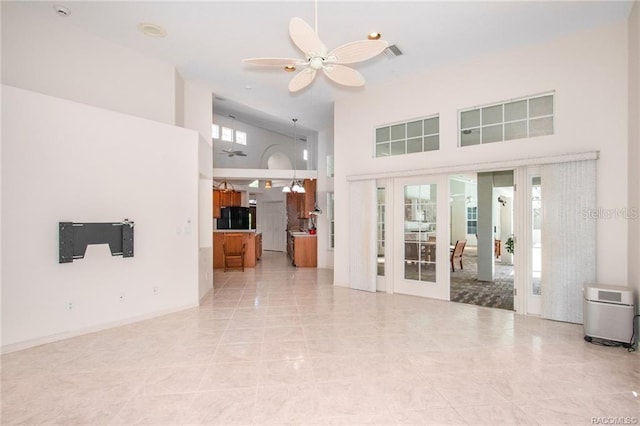 unfurnished living room featuring ceiling fan, french doors, high vaulted ceiling, and light tile patterned floors