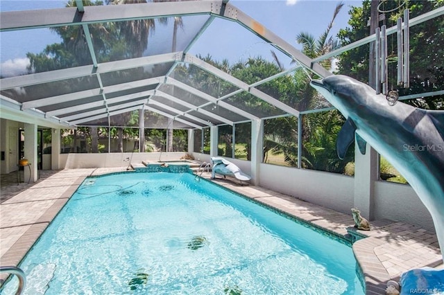 view of swimming pool with a lanai and a patio