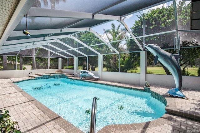 view of pool with a patio and a lanai