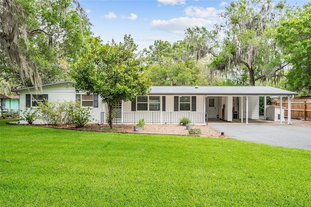 ranch-style home featuring a carport, a porch, and a front yard