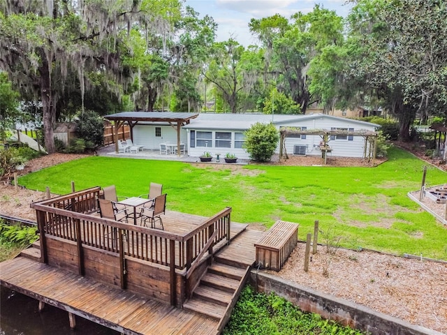 back of house with a yard, a deck, a pergola, and a patio area