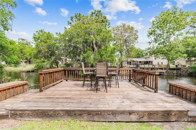 wooden deck featuring a water view