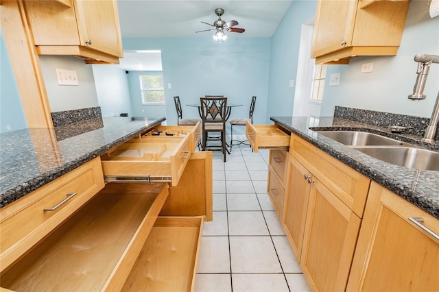 kitchen featuring ceiling fan, butcher block counters, light tile patterned floors, and sink