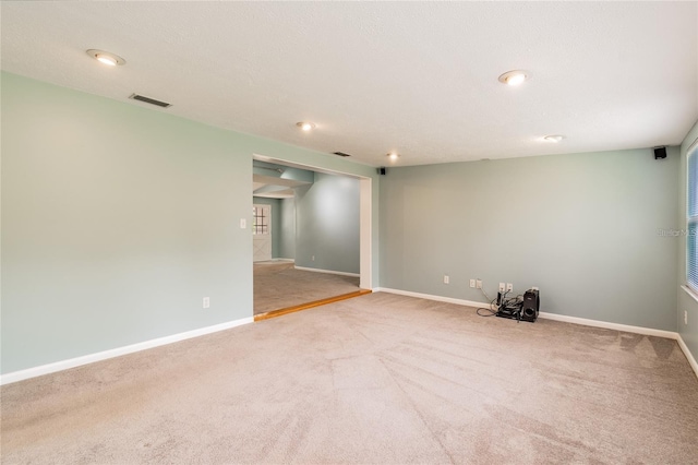 empty room featuring a textured ceiling and carpet floors