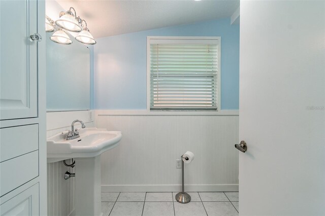 bathroom featuring tile patterned floors, a textured ceiling, and vaulted ceiling