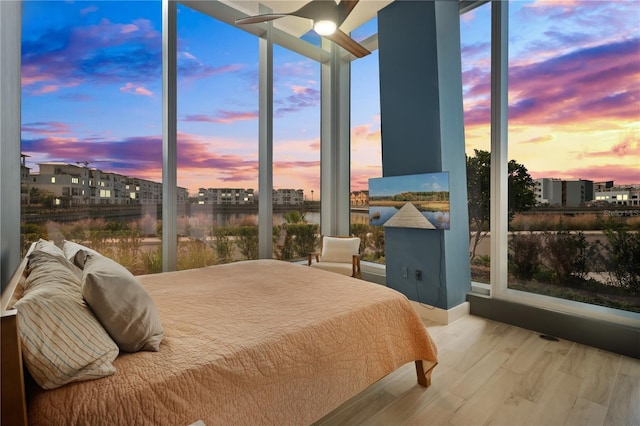 bedroom with light hardwood / wood-style floors and ceiling fan