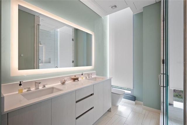 bathroom featuring tile patterned floors, a shower with door, vanity, and toilet