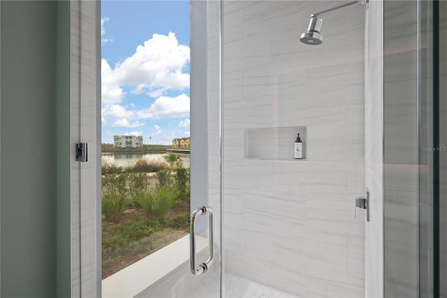 bathroom with a shower with door