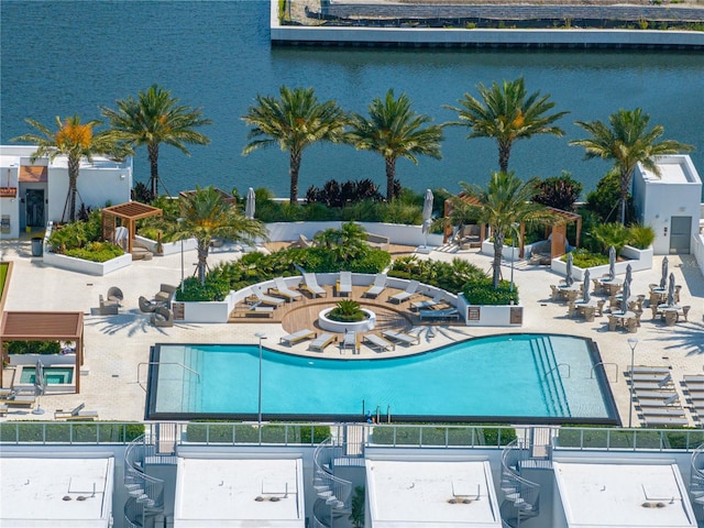 view of pool with a patio area and a water view