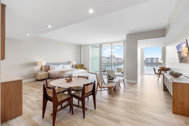 dining room featuring light hardwood / wood-style floors and a wall of windows