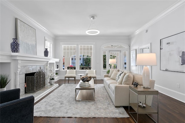 living room with ornamental molding, dark wood-type flooring, and a tiled fireplace