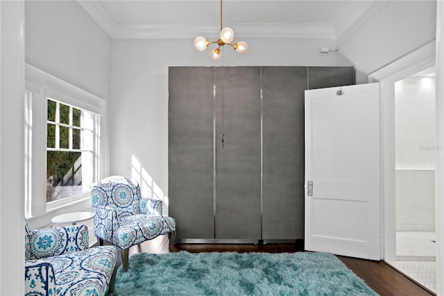 sitting room featuring crown molding, dark hardwood / wood-style floors, and a notable chandelier