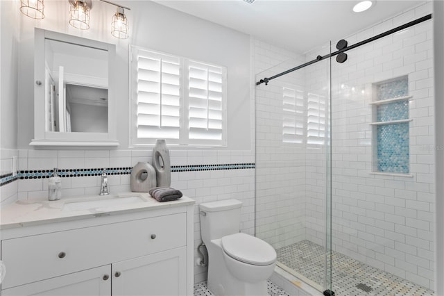 bathroom featuring toilet, tile walls, and a shower with shower door