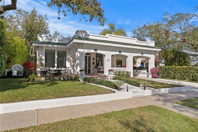 view of front facade featuring a front lawn and covered porch