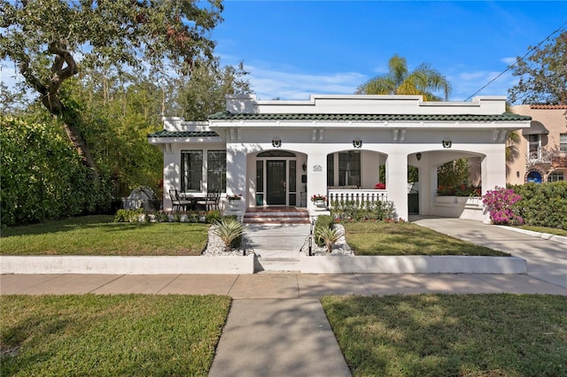 view of front of home with a porch and a front yard