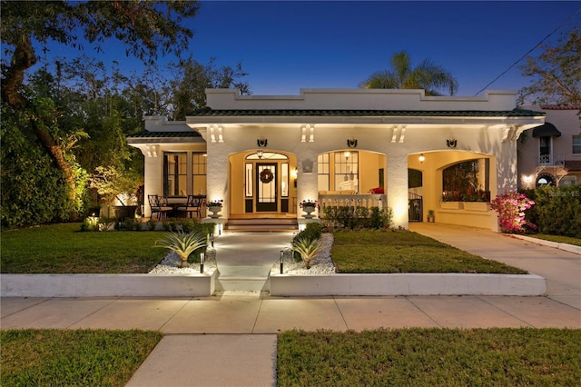 view of front of home with a yard